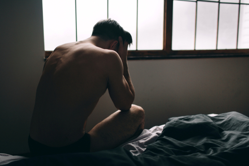 Depressed Man Sitting In An Empty Room - Men's sexual Health