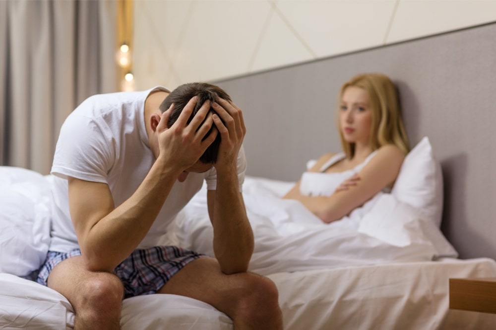 Man dealing with stress in bed