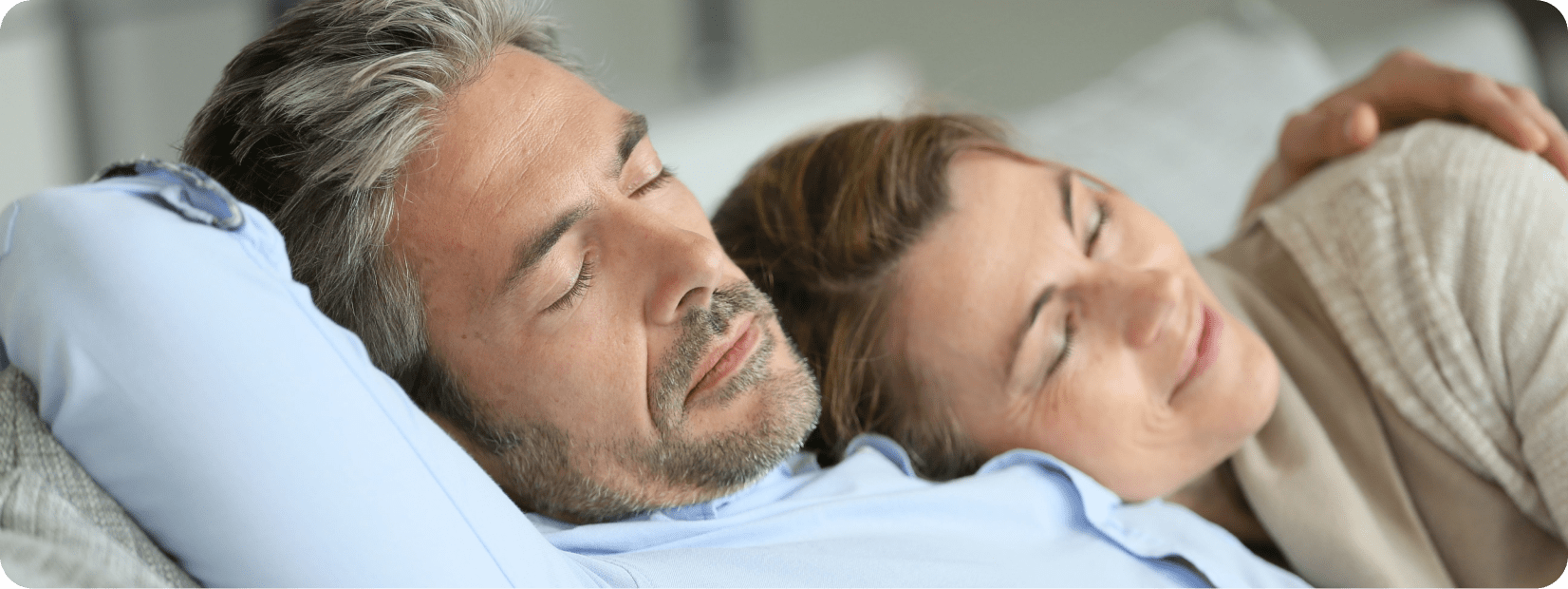 50 Year old couple napping together intimately