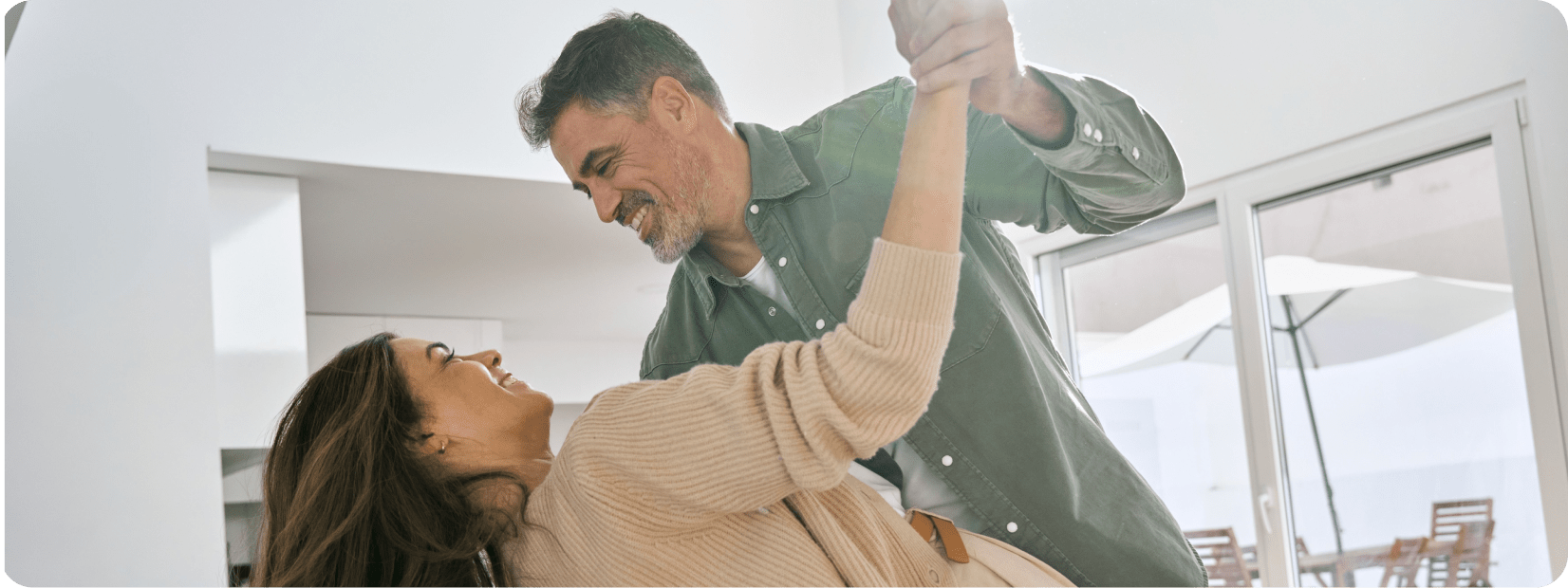 Happy couple dancing together in the house