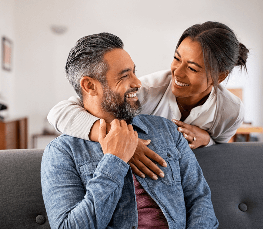 young asian couple smiling in living room