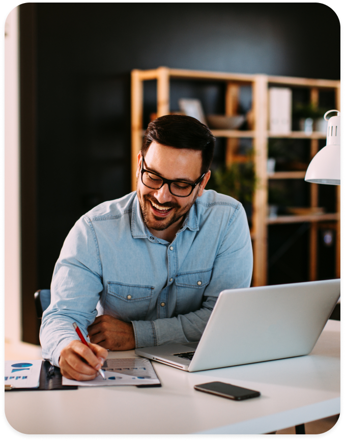 man smiling working on laptop