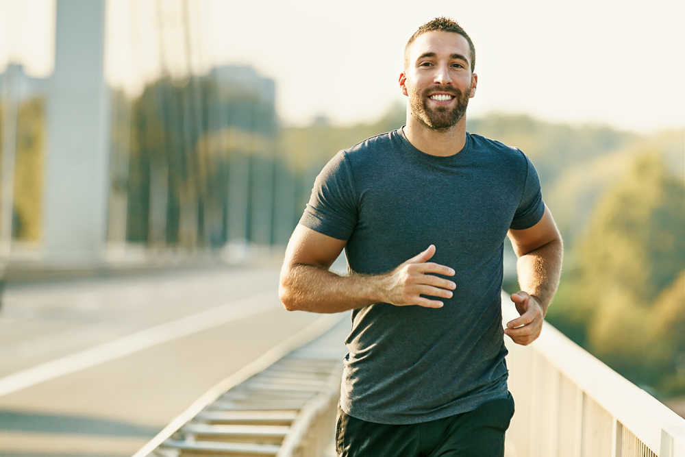 Young Man Running Across Bridge - Healthy Testosterone levels
