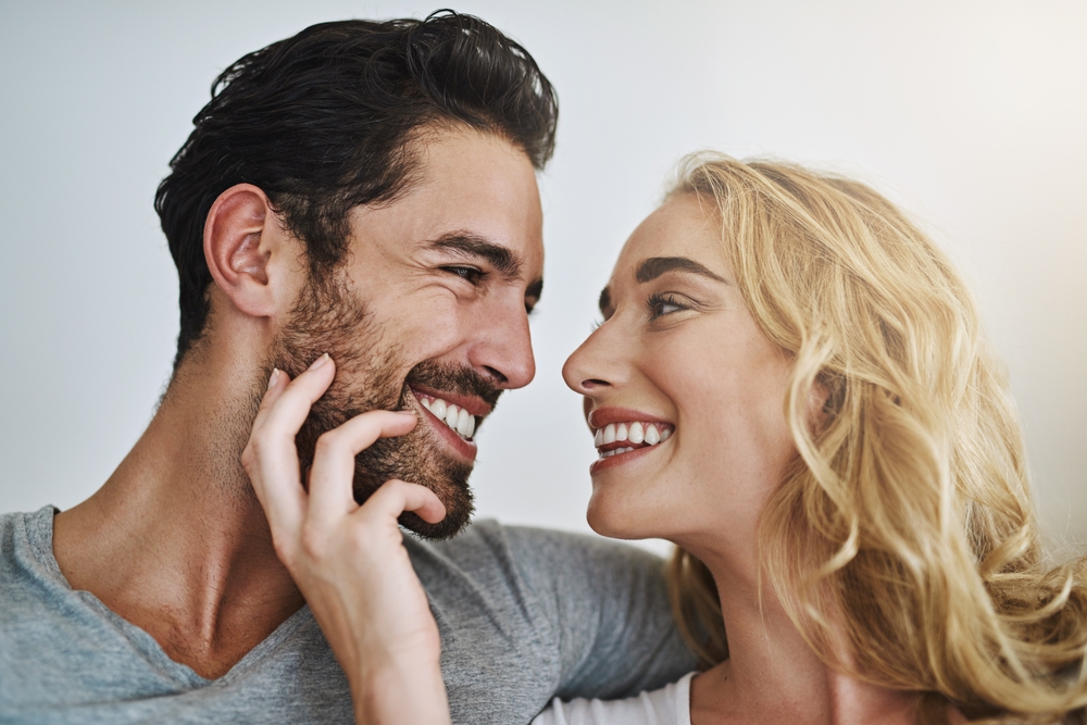 young couple smiling at eachother