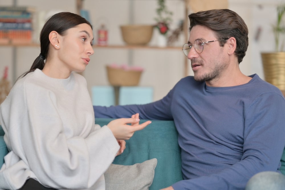 young couple having a conversation on the couch